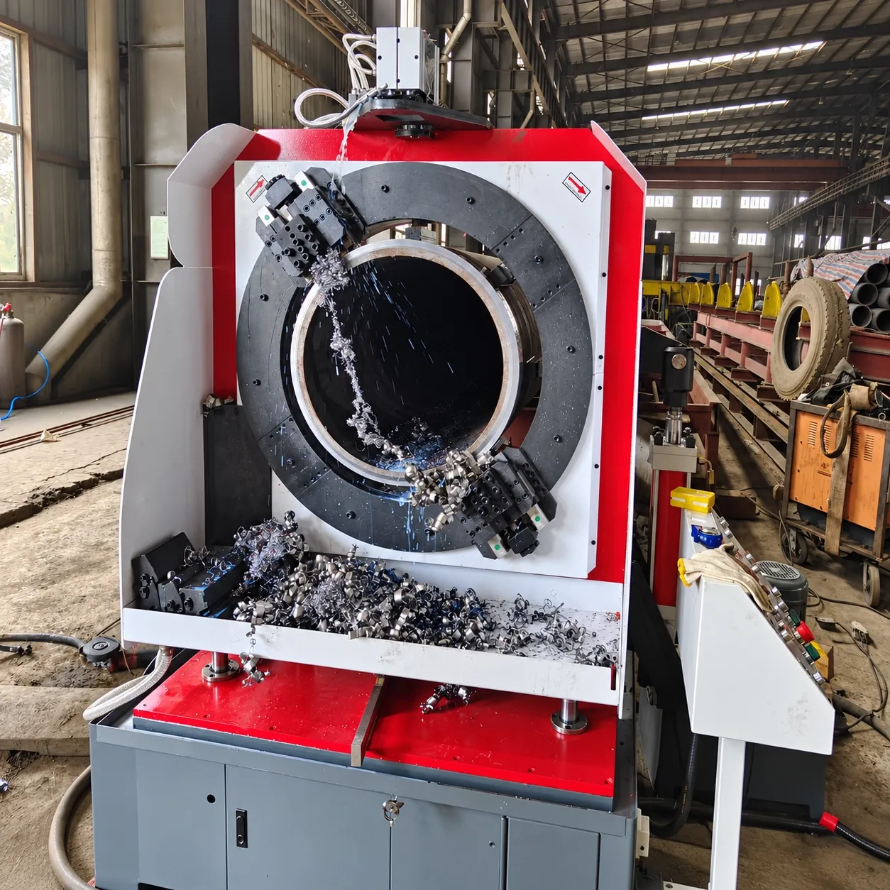 DCM workshop pipe cutter machining a large pipe end, chips and coolant at the cutter