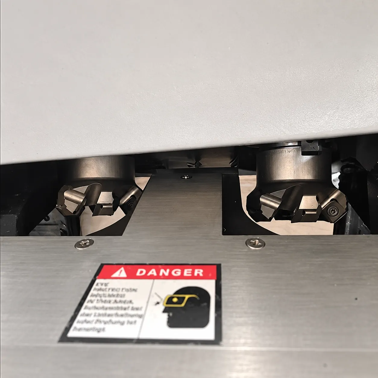 Close-up of the DMM-900X twin cutter heads with indexable CNC inserts