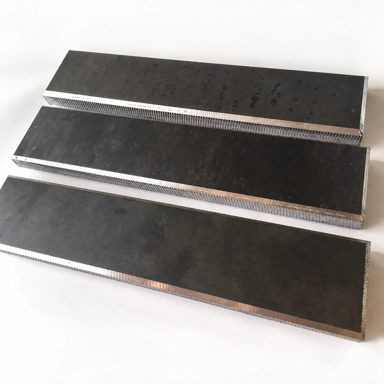 Three steel strips with long edges bevelled on the DZ