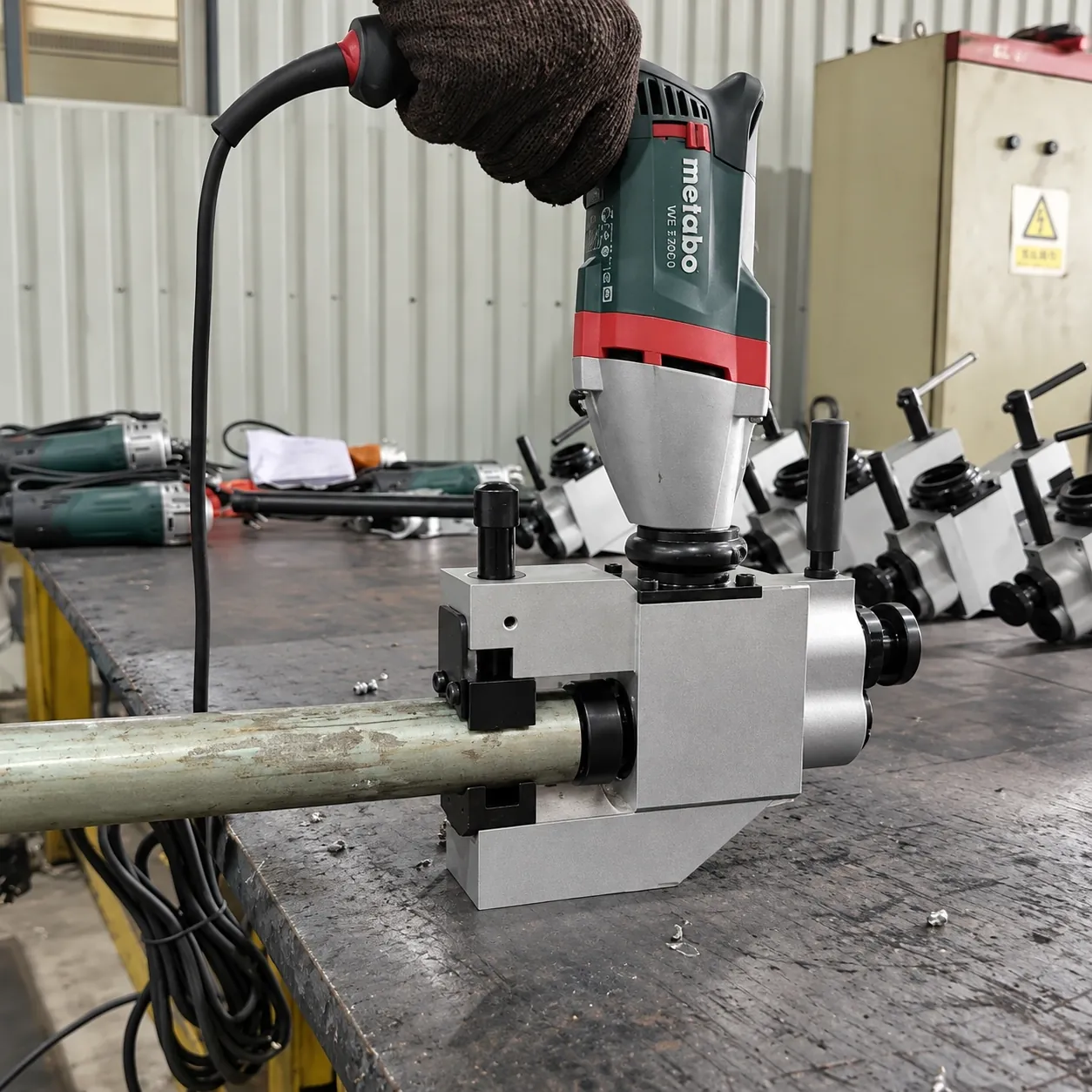 ISC external-clamping beveler clamped on a tube at the workbench