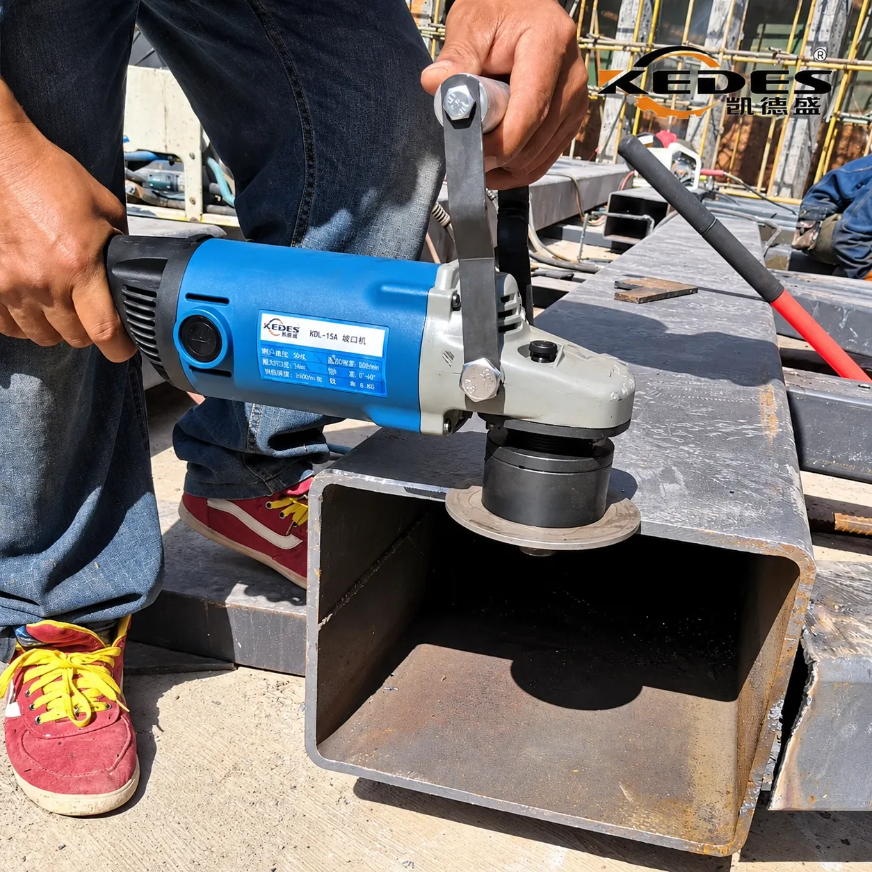 Operator bevelling the edge of a steel box section on site with the HDL handheld edge miller