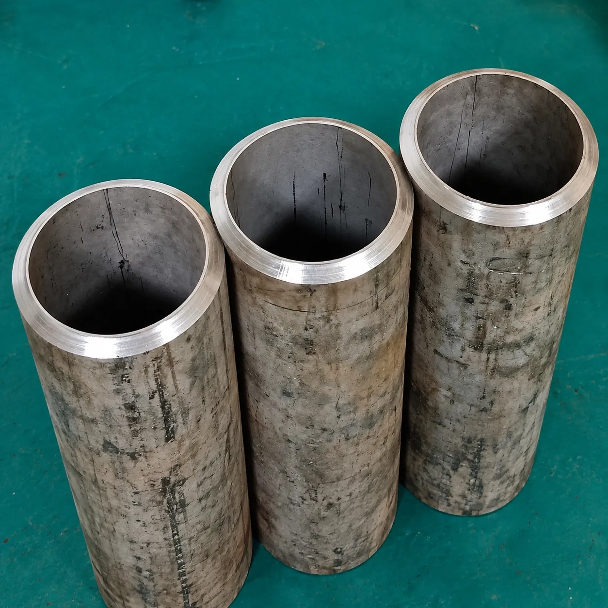 Three pipe sections with clean bevelled ends, ready for welding