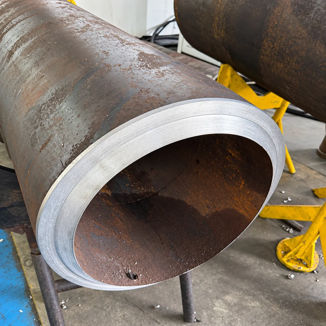 Close-up of a heavy-wall pipe end with a machined bevel and land