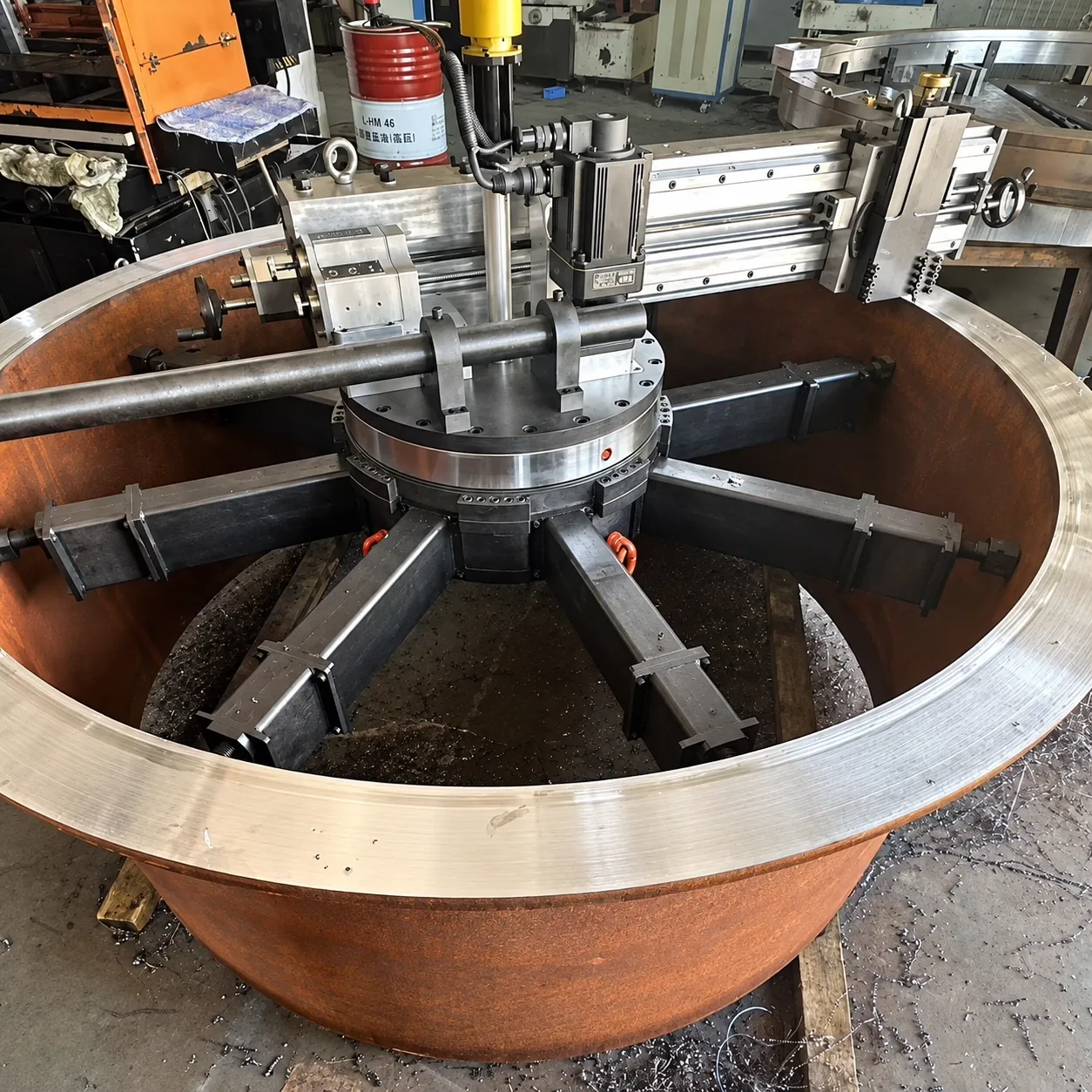 Portable flange facer mounted inside a large flange bore on radial legs, facing the raised face
